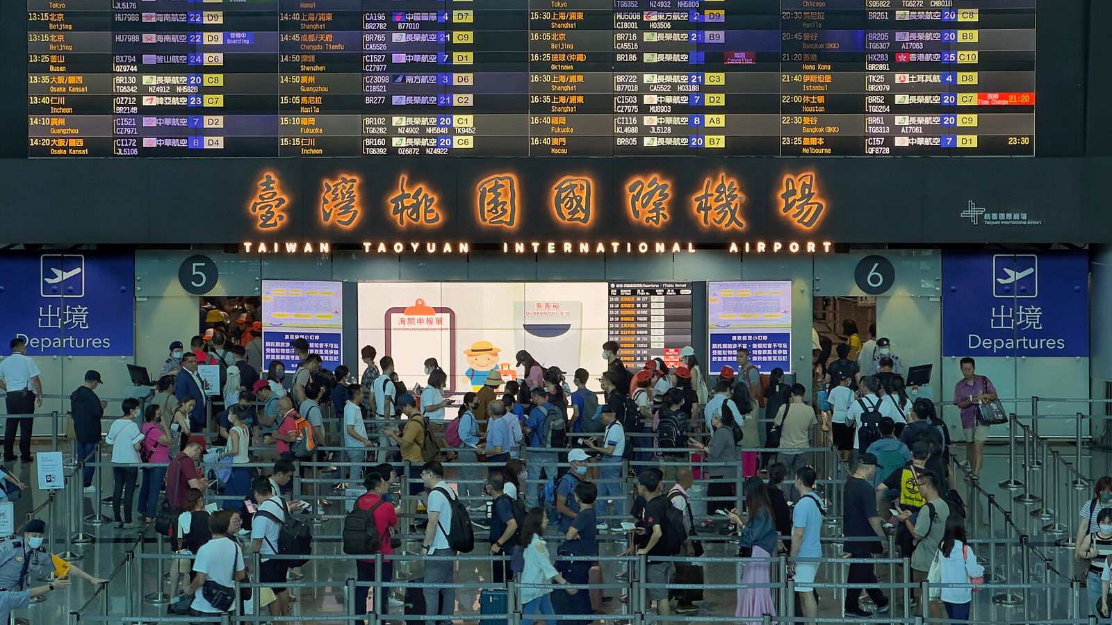 Passengers queuing at an airport security checkpoint