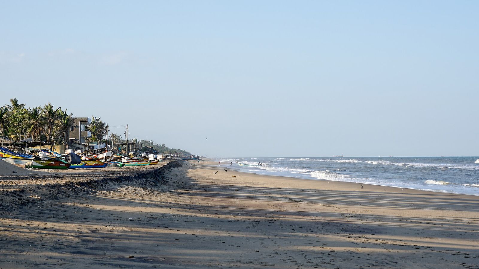 A working fishing village beside a beach
