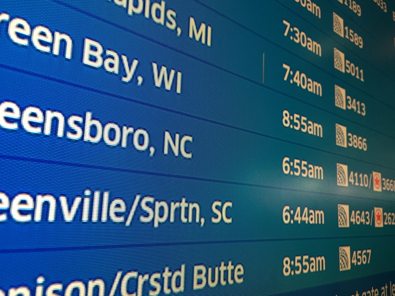 Flight departure board listing international departures in an airport terminal