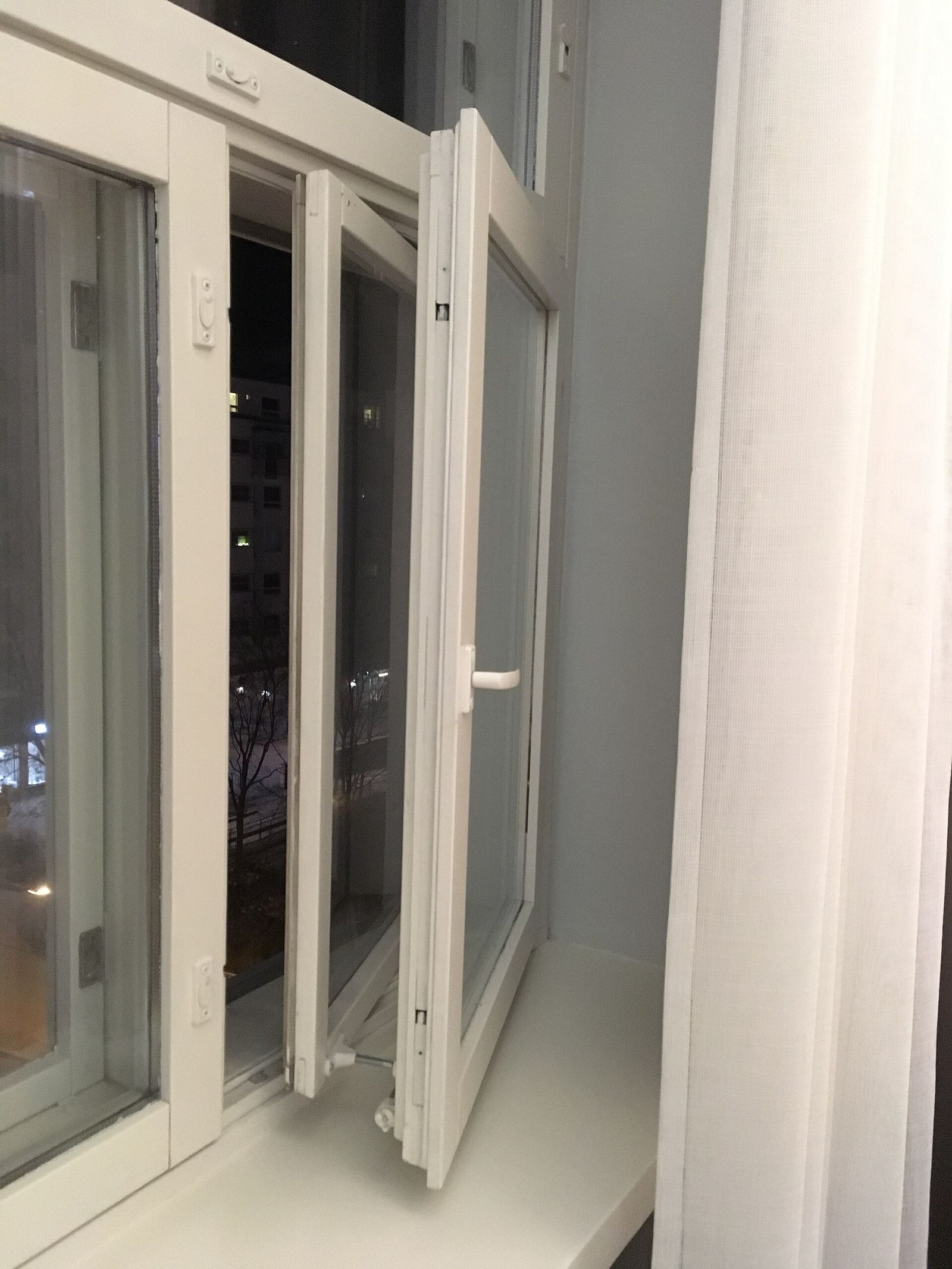 A hotel room window looking onto a city street