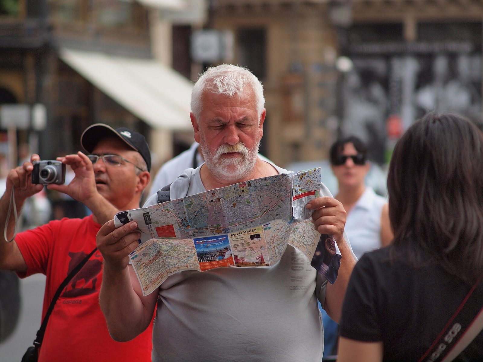 A traveller studying a folded Paris city map while planning the day's route