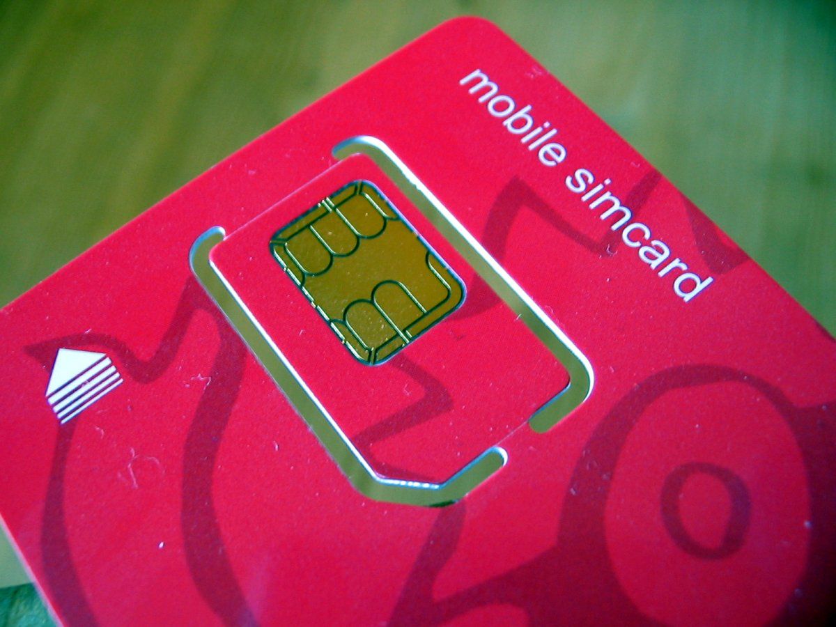 A SIM card being fitted to a mobile phone